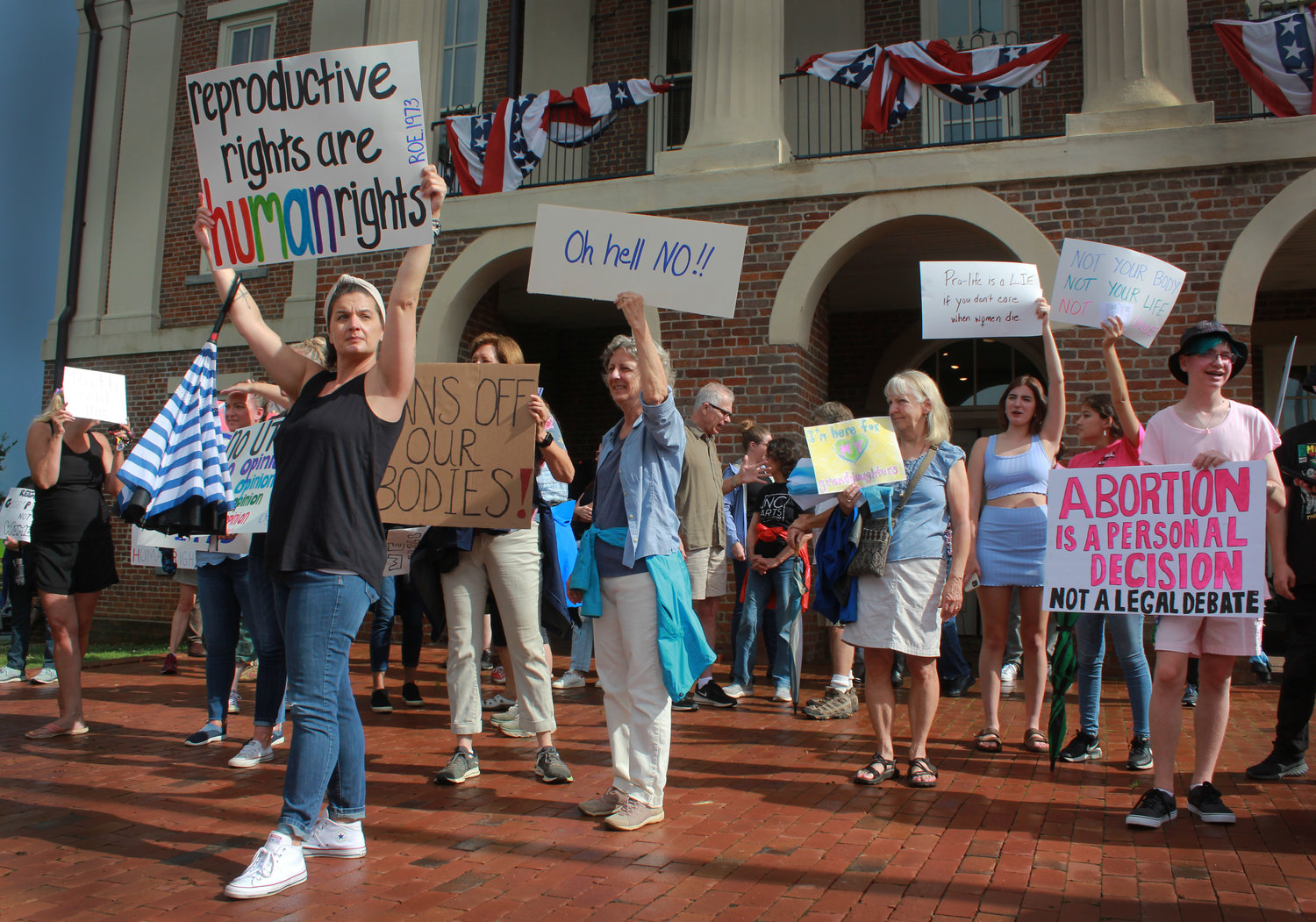Protesters hold signs and chant outside of the Pittsboro Historic Courthouse  during the abortion and women’s rights protest on Monday in Pittsboro. Pittsboro Mayor Cindy Perry and Chatham County Commisioner Karen Howard were some of the more notable participants at the rally.